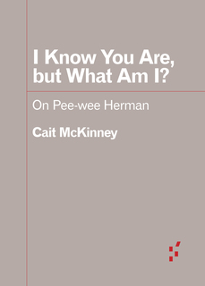 Gray background with white title text adorned with red rules, suggestive of Pee-wee’s suit.