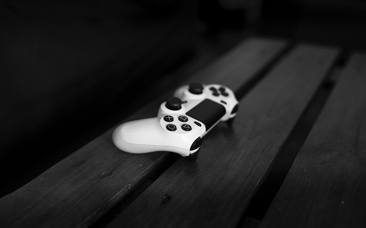 Console video game controller on a wooden bench