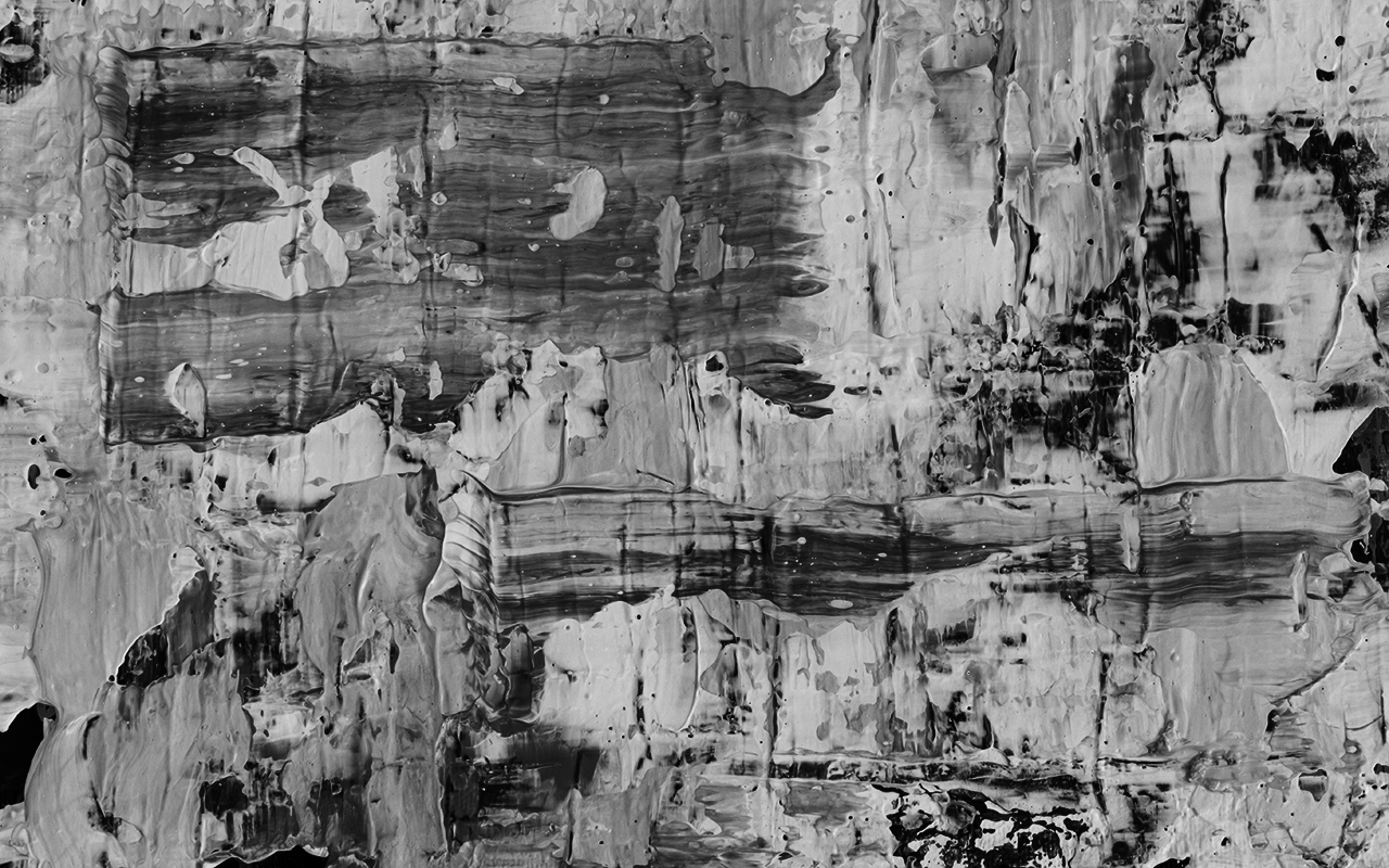 Abstract splatter paint artwork in grayscale.