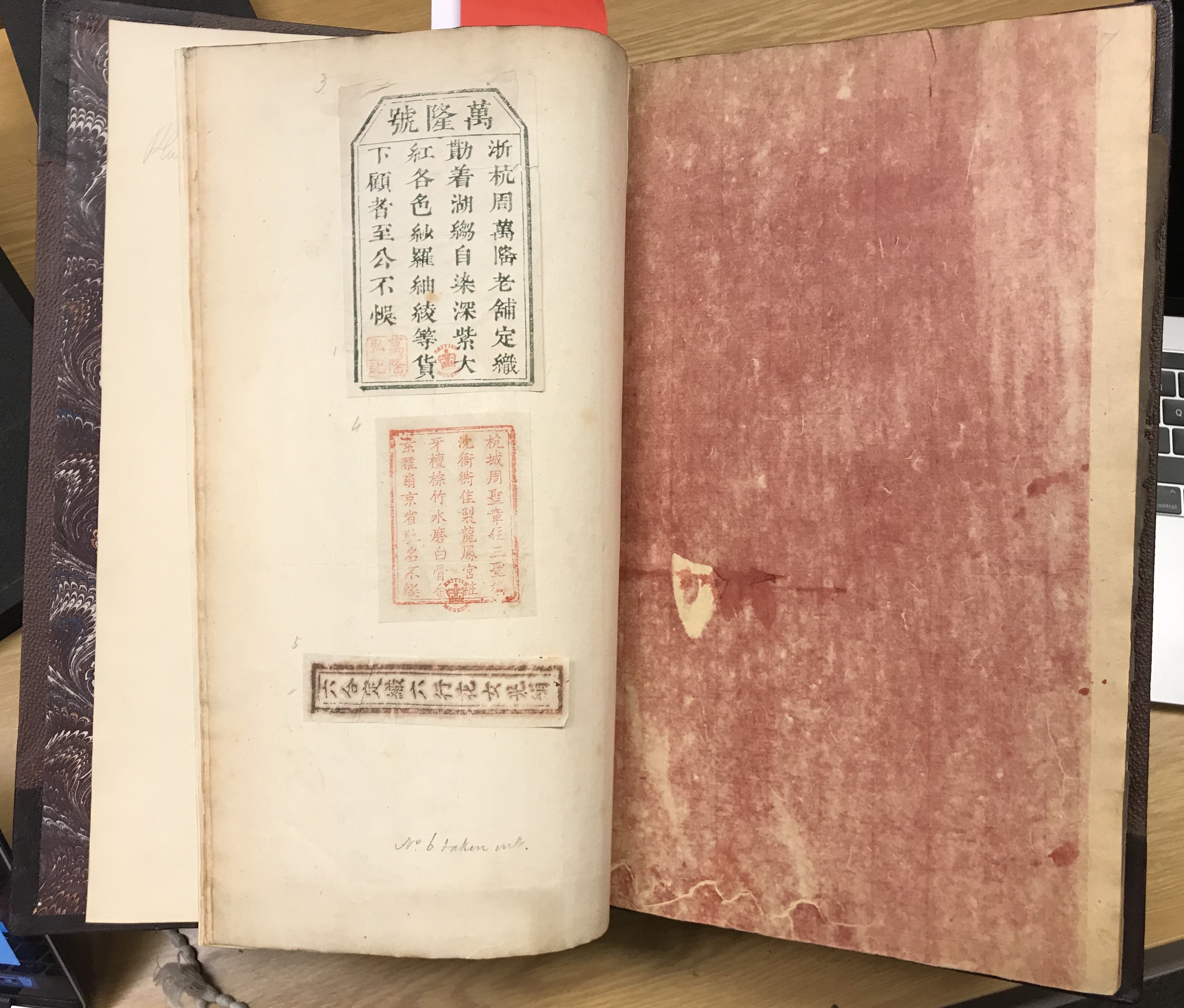 Photograph of specimens of Chinese printing pasted into a large volume of specimens